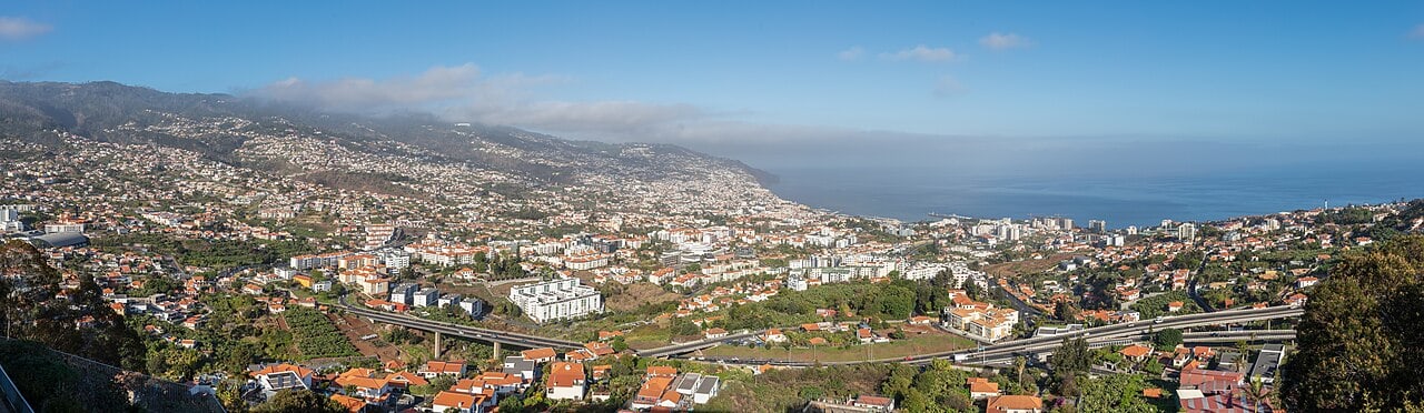 Funchal spreads across hills toward the harbour, showing the slopes above the waterfront walks.