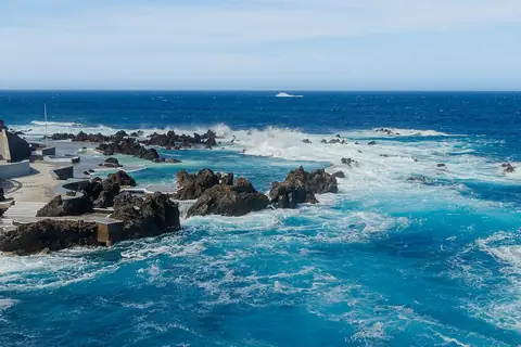 Atlantic waves break around Porto Moniz’s volcanic pools, beside a walk along the waterfront.